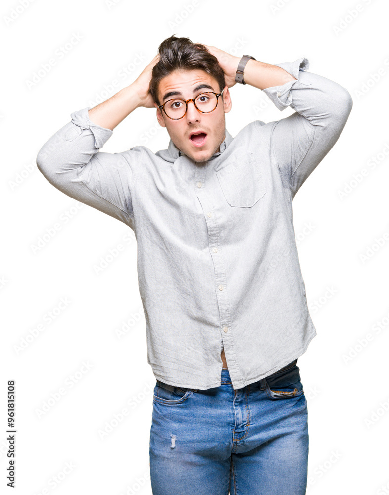Young handsome man wearing glasses over isolated background Crazy and scared with hands on head, afraid and surprised of shock with open mouth Young handsome man wearing glasses over isolated background Crazy and scared with hands on head, afraid and surprised of shock with open mouth