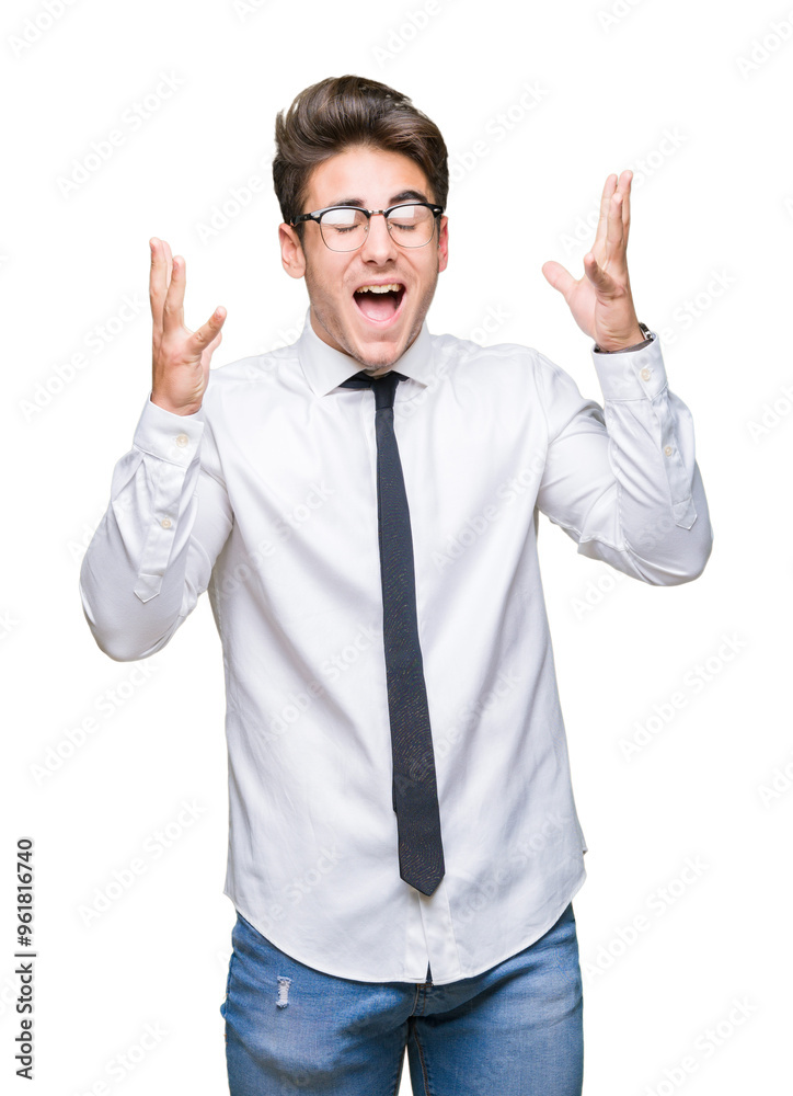 Young business man wearing glasses over isolated background celebrating mad and crazy for success with arms raised and closed eyes screaming excited. Winner concept Young business man wearing glasses over isolated background celebrating mad and crazy for success with arms raised and closed eyes screaming excited. Winner concept