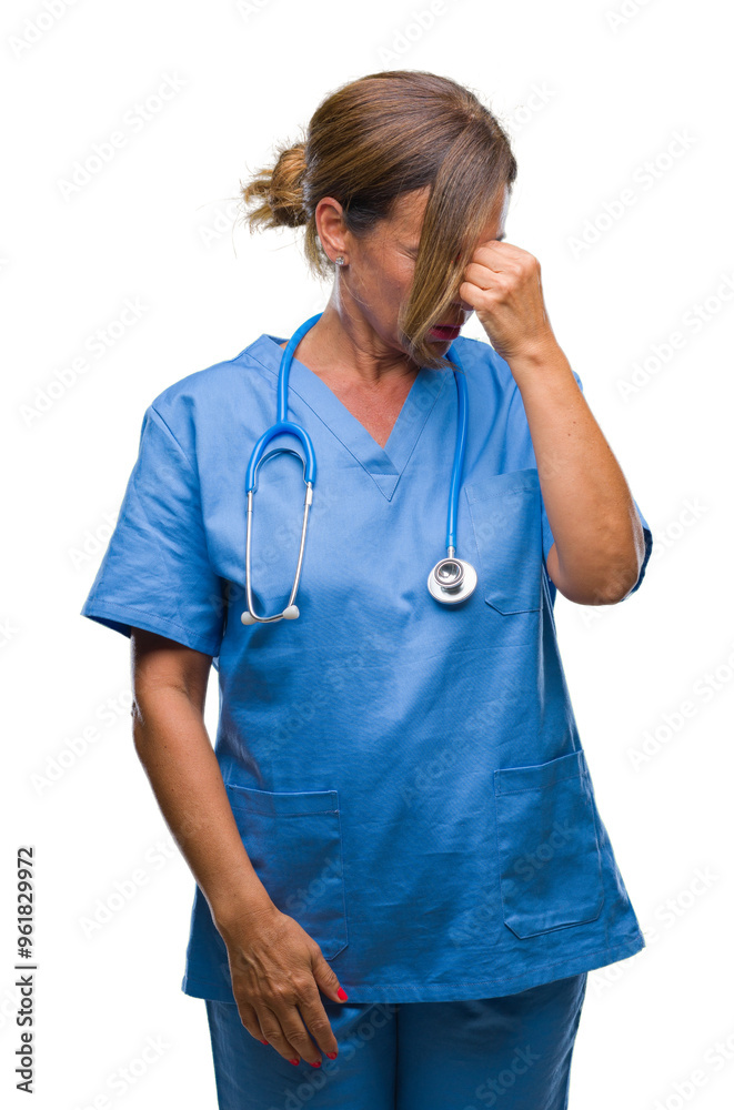 Middle age senior nurse doctor woman over isolated background tired rubbing nose and eyes feeling fatigue and headache. Stress and frustration concept. Middle age senior nurse doctor woman over isolated background tired rubbing nose and eyes feeling fatigue and headache. Stress and frustration concept.