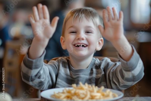 Excited boy orange shirt expresses joy and curiosity table. Candid image of delighted child relatable home setting. Childhood joy and anticipation mealtime. photo