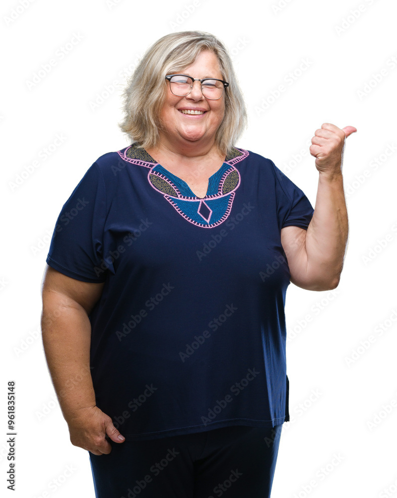 Senior plus size caucasian woman wearing glasses over isolated background smiling with happy face looking and pointing to the side with thumb up. Senior plus size caucasian woman wearing glasses over isolated background smiling with happy face looking and pointing to the side with thumb up.