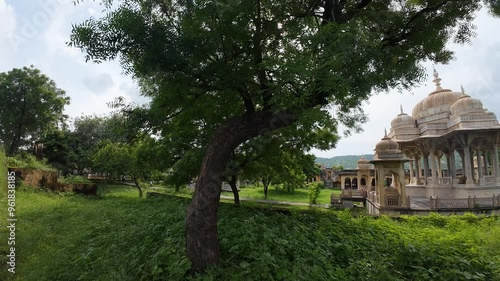 Exploring the stunning architecture of a historic 
 ruins at Maharaniyon Ki Chhatriyan  amidst lush greenery in Rajasthan during the golden hour photo