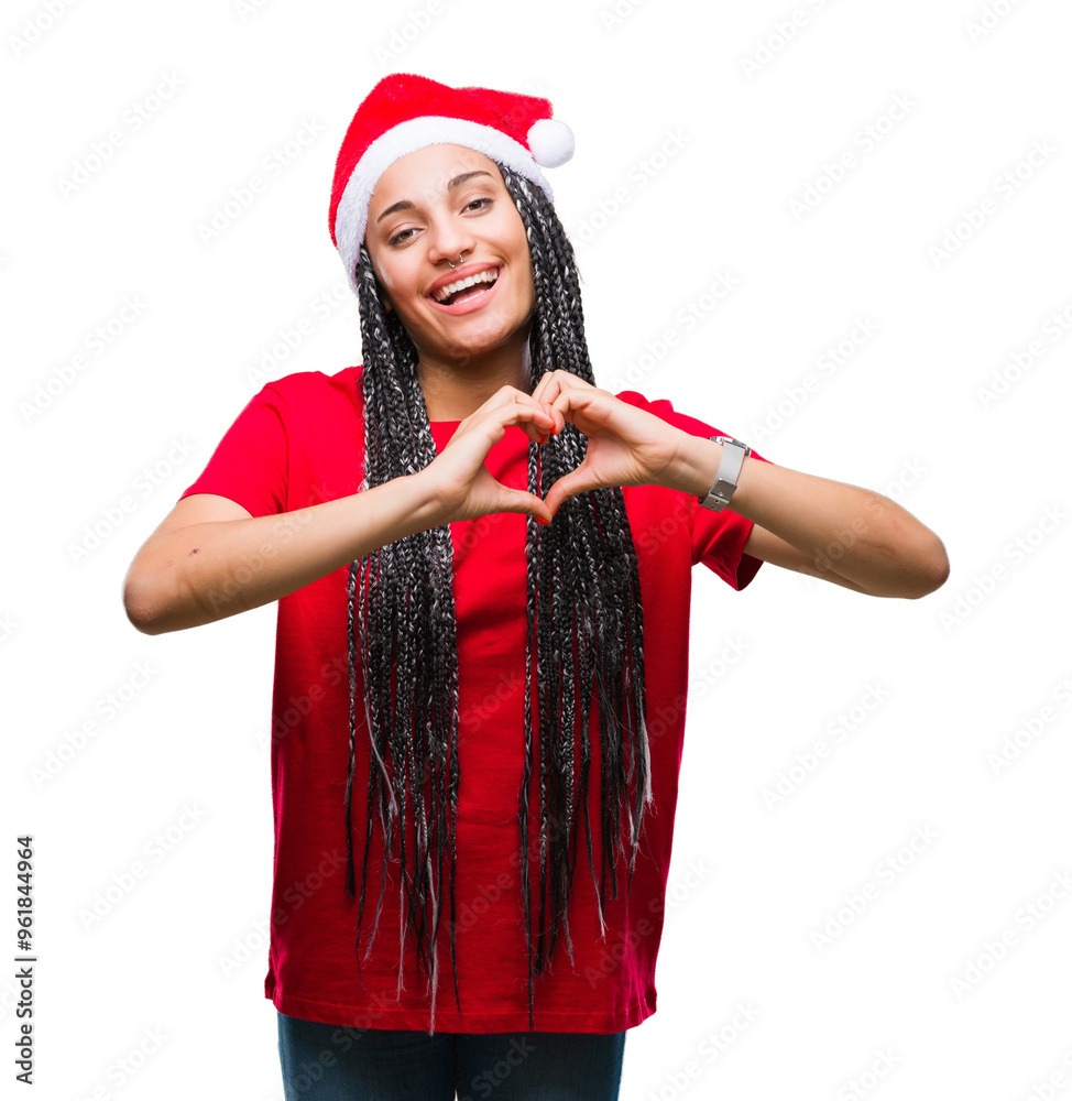 © Krakenimages.com - Young braided hair african american girl wearing christmas hat over isolated background smiling in love showing heart symbol and shape with hands. Romantic concept.