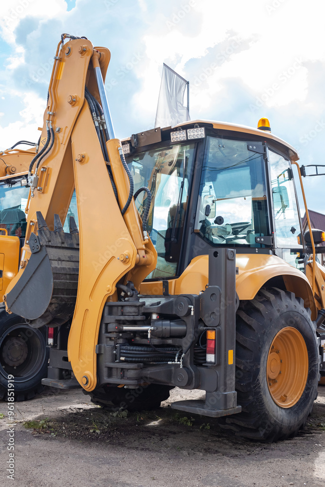 Yellow excavator at the back. Construction equipment. Yellow excavator at the back. Construction equipment.
