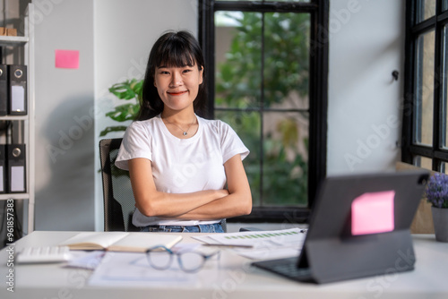 Young asian businesswoman smiling while working at the office