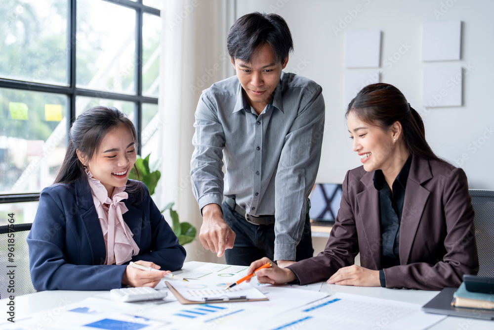 Businesspeople discussing and brainstorming on a document at meeting Businesspeople discussing and brainstorming on a document at meeting