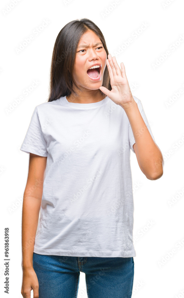 Young asian woman over isolated background shouting and screaming loud to side with hand on mouth. Communication concept. Young asian woman over isolated background shouting and screaming loud to side with hand on mouth. Communication concept.