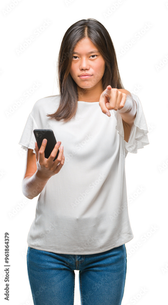 Young asian woman texting using smartphone over isolated background pointing with finger to the camera and to you, hand sign, positive and confident gesture from the front Young asian woman texting using smartphone over isolated background pointing with finger to the camera and to you, hand sign, positive and confident gesture from the front