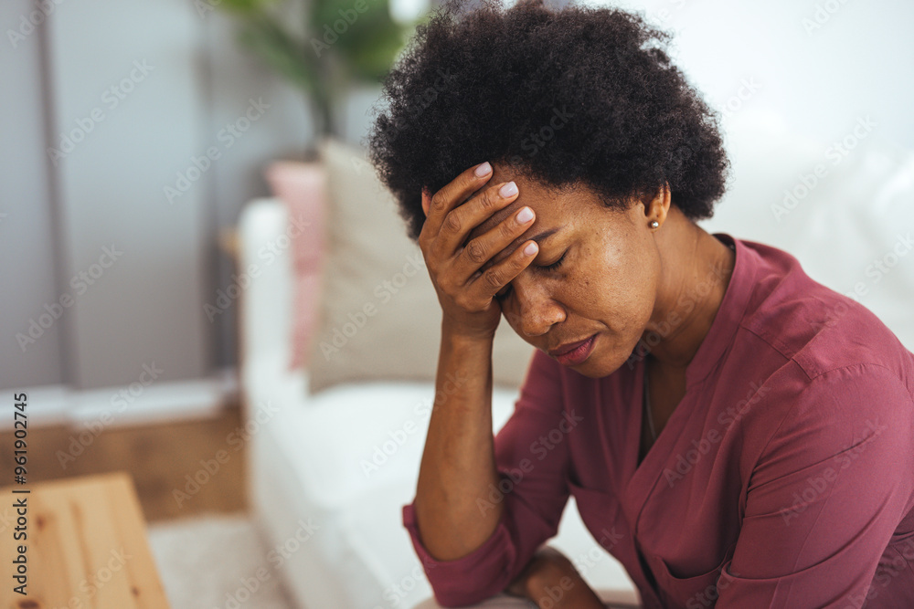 Stressed Woman Sitting on Sofa in Living Room Stressed Woman Sitting on Sofa in Living Room