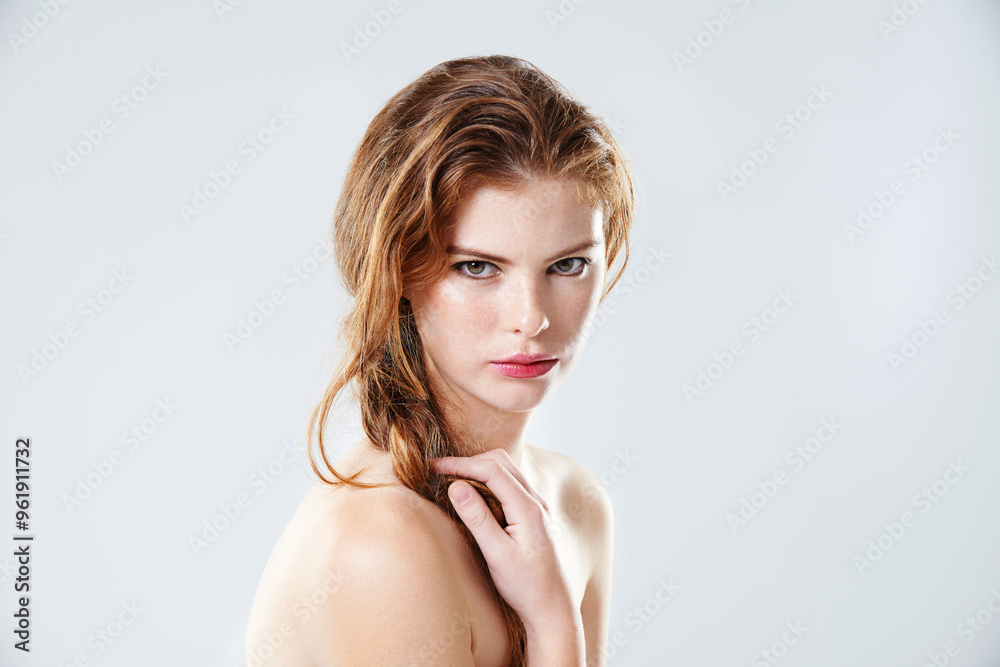 Woman, portrait and serious in studio for makeup, application and beauty cosmetic with lipstick. Model, face and shine on white background for skin glow, aesthetic or facial transformation in Ireland Woman, portrait and serious in studio for makeup, application and beauty cosmetic with lipstick. Model, face and shine on white background for skin glow, aesthetic or facial transformation in Ireland