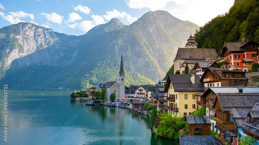 Charming lakeside village of Hallstatt, Austria basking in golden sunlight on a serene afternoon Charming lakeside village of Hallstatt, Austria basking in golden sunlight on a serene afternoon