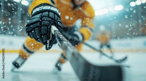 Dynamic ice hockey player gliding effortlessly across the rink, stick poised, puck in motion, minimalist arena setting emphasizes skill and athleticism in a vibrant sport. photo