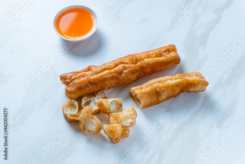 Youtiao or Yu Char Kway or cakwe is a long golden-brown deep-fried strip of wheat flour dough of Chinese origin. Perfect for recipe, article, catalogue, commercial, or any cooking content. photo