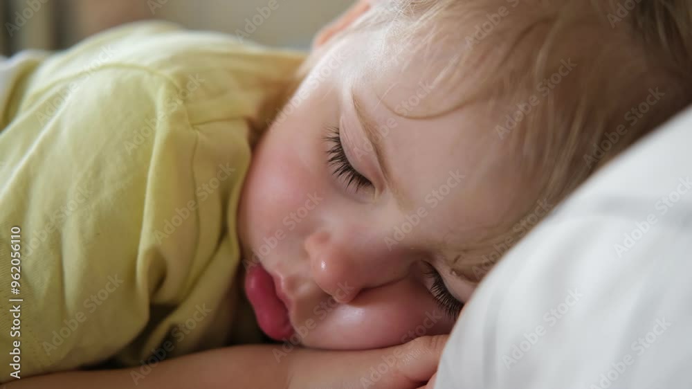 Peaceful adorable baby sleeping on a bed at home. Slumbering little child. Two years old girl sleeps peaceful at domestic room interior background. Serene dream. Cute face close up. Deep kid slumber Peaceful adorable baby sleeping on a bed at home. Slumbering little child. Two years old girl sleeps peaceful at domestic room interior background. Serene dream. Cute face close up. Deep kid slumber