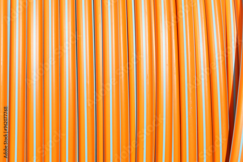 background of orange tube reel for laying fiber optics for very high speed internet connections photo