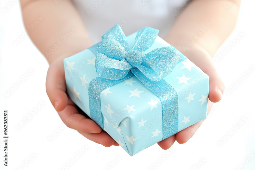 Close up of a hand of a young child offering a gift