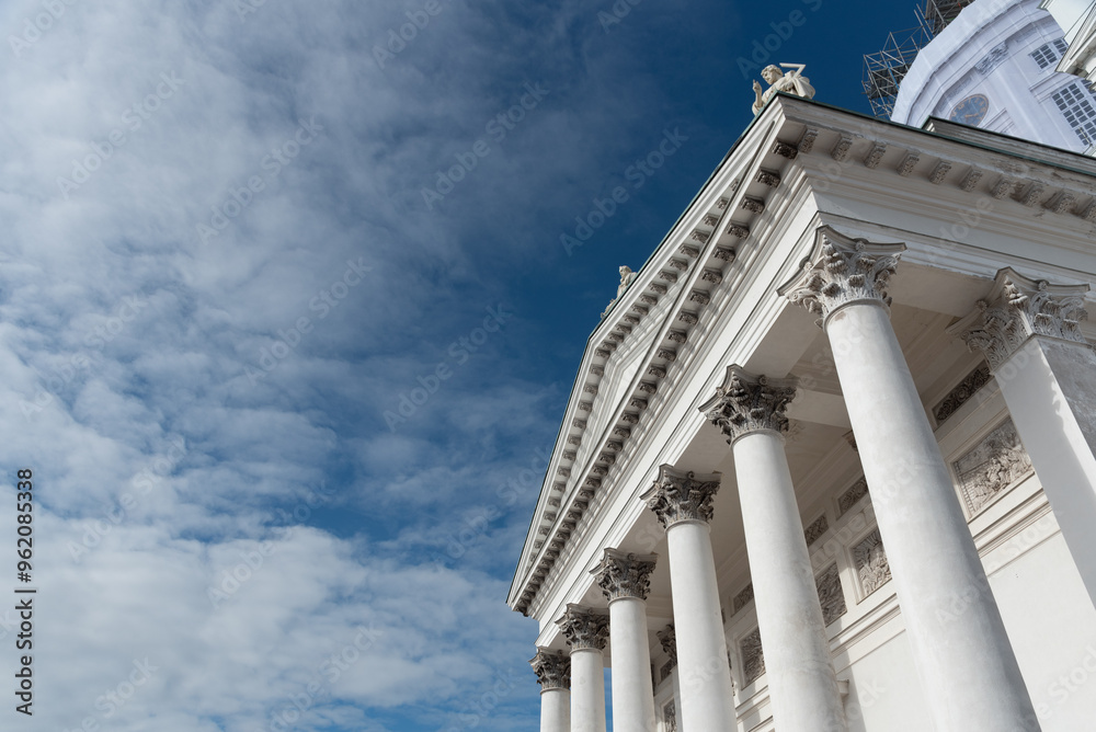 Low angle view of details of the neoclassical style architecture of the cathedral of Helsinki against cloudy sky