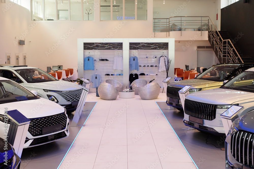 Φωτογραφία Wide angle shot of two storey car dealership showroom with no people featuring l
