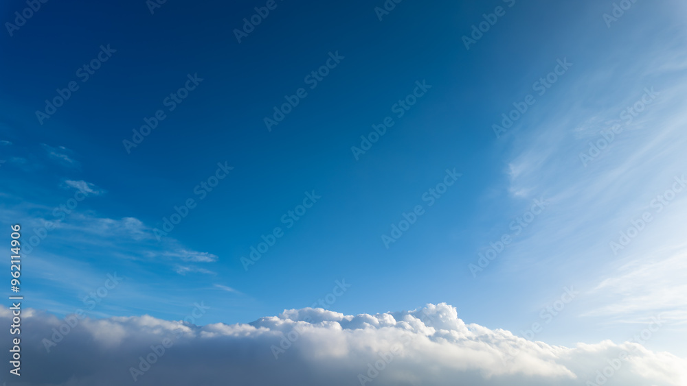 The blue sky with white clouds seen from mountain peak or aeroplane during sunny day. Empty blank copy text space. Concept for heaven. The blue sky with white clouds seen from mountain peak or aeroplane during sunny day. Empty blank copy text space. Concept for heaven.