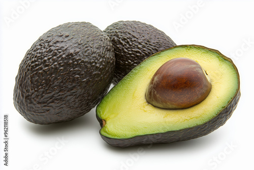 Whole and half of ripe avocado.