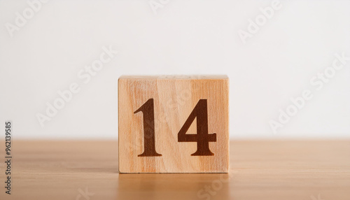 Wooden cube with number 14 on wooden table, white wall on background. Event planner, calendar