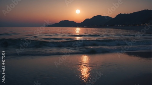 Luminous Moonlight Reflection on a Tranquil Ocean Beach at Night. photo