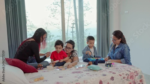 video of family playing in bed