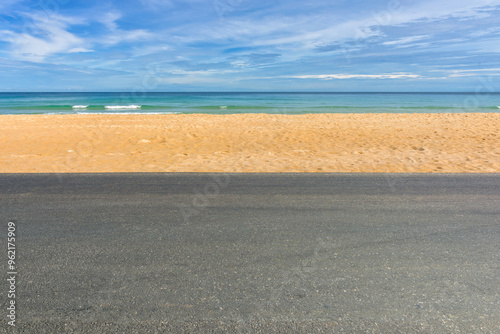 Fototapeta Naklejka Na Ścianę i Meble -  Side view of asphalt road with beach on sea and beautiful blue sky.