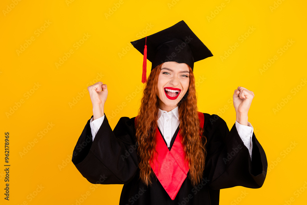 Photo of glad charming girl graduate wear black mantle finish course studying isolated on yellow color background Photo of glad charming girl graduate wear black mantle finish course studying isolated on yellow color background