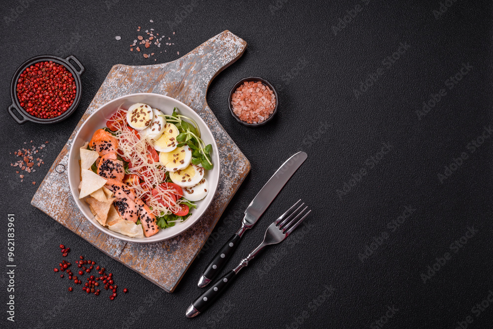 Delicious fresh caesar salad with salmon, lettuce, tomatoes and egg Delicious fresh caesar salad with salmon, lettuce, tomatoes and egg