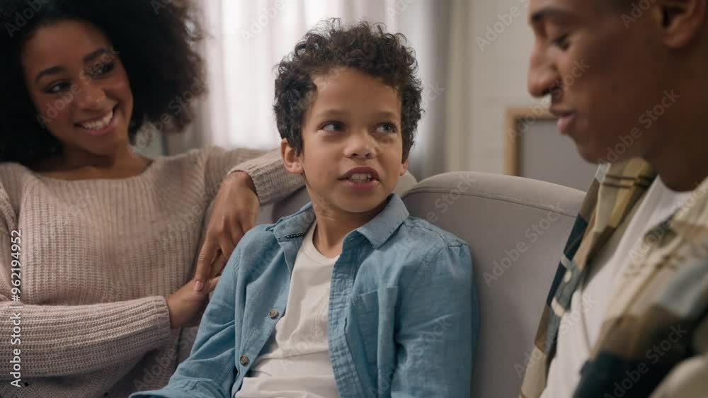 African American family conversation young mother female woman mom man father dad male talking telling preschool child son little boy parents listening kid enjoying spending leisure time together room African American family conversation young mother female woman mom man father dad male talking telling preschool child son little boy parents listening kid enjoying spending leisure time together room
