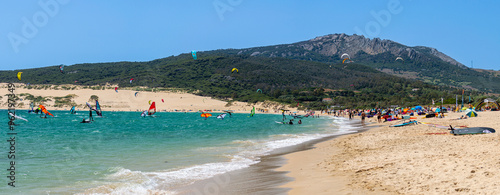 Enjoying kitesurfing on Valdevaqueros beach, Gibraltar Strait in Tarifa, Spain