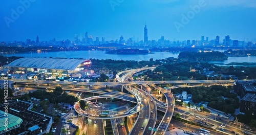 Aerial shot of viaduct road and city skyline with lake in Nanjing, China photo