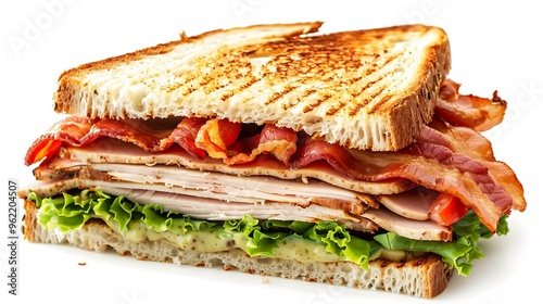 Classic club sandwich piled with turkey, lettuce, tomato, and bacon, presented between slices of golden toasted bread.
