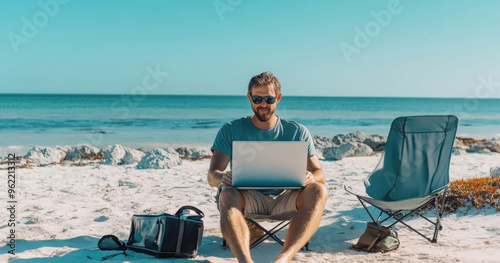 A man sitting on the beach with his laptop, working as an online marketing expert for travel enthusiasts and nomads