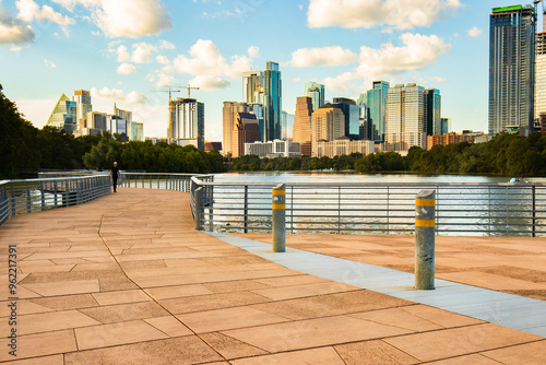  Austin, Texas skyline from the Boardwalk Trail at Lady Bird Lake. The shot features modern skyscrapers, including notable buildings like the Frost Bank Tower and Austonian. photo