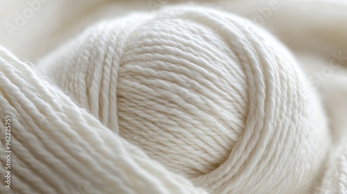 A close-up shot of a white yarn ball. This photo is perfect for projects related to crafts, knitting, and textiles.