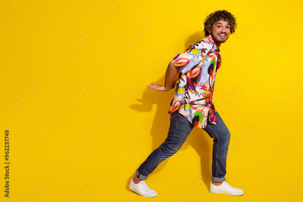 Full size profile photo of nice young man carry empty space wear shirt isolated on yellow color background Full size profile photo of nice young man carry empty space wear shirt isolated on yellow color background