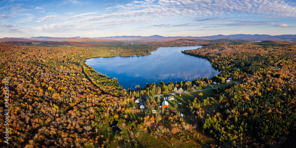Obraz premium Aerial View of Northern New England Lake With Cloud Reflection Surrounded By Vibrant Fall Foliage - Back Lake in Pittsburg, New Hampshire 