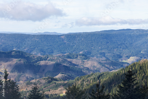 View over the mountain range in winter with clouds, forest and fog in the Black Forest