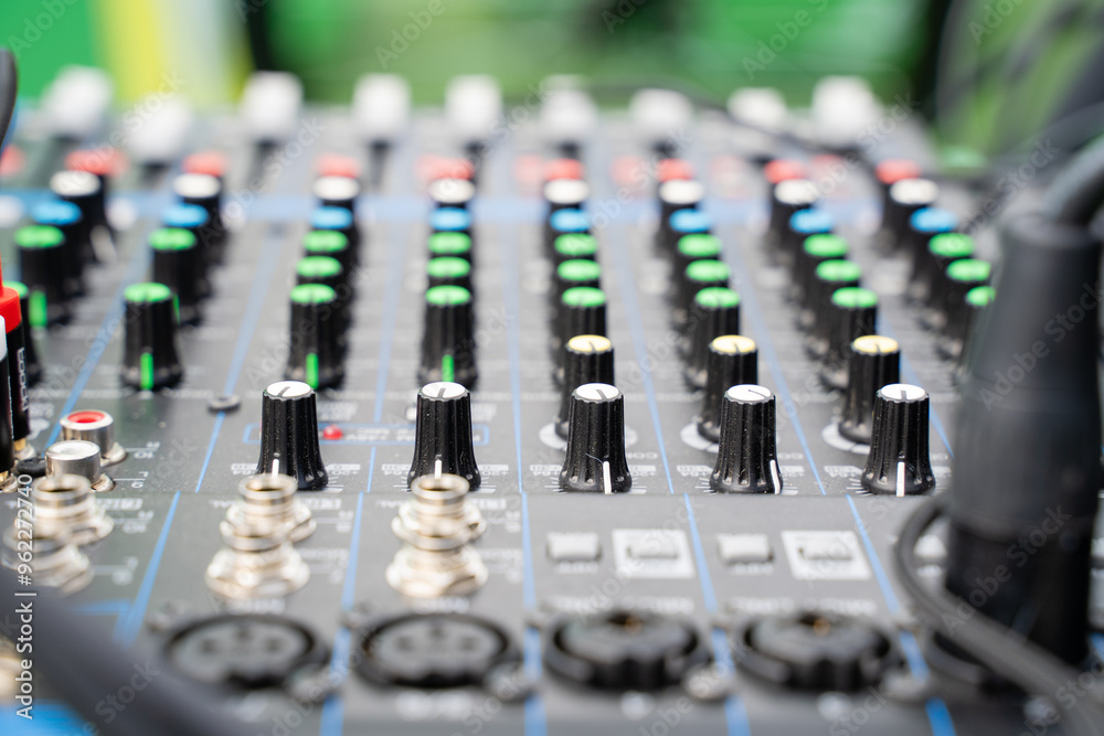 Here is a detailed close up of a mixer featuring numerous knobs and buttons Here is a detailed close up of a mixer featuring numerous knobs and buttons