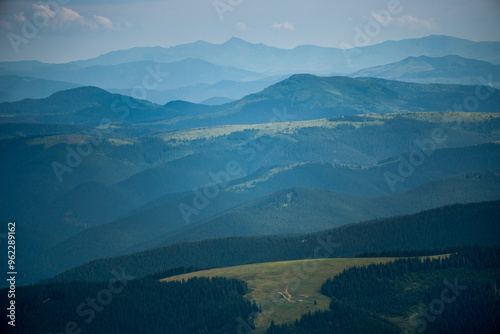 beautiful Carpathian landscape of pasture below with silhouettes of mountains...