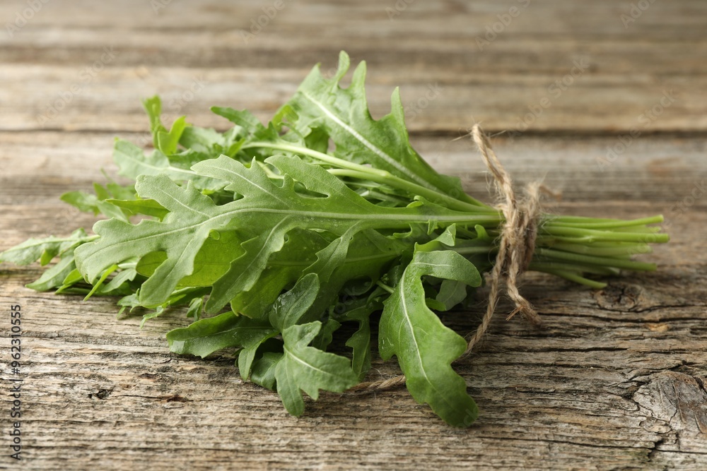 Bunch of fresh green arugula leaves on wooden table, closeup Bunch of fresh green arugula leaves on wooden table, closeup