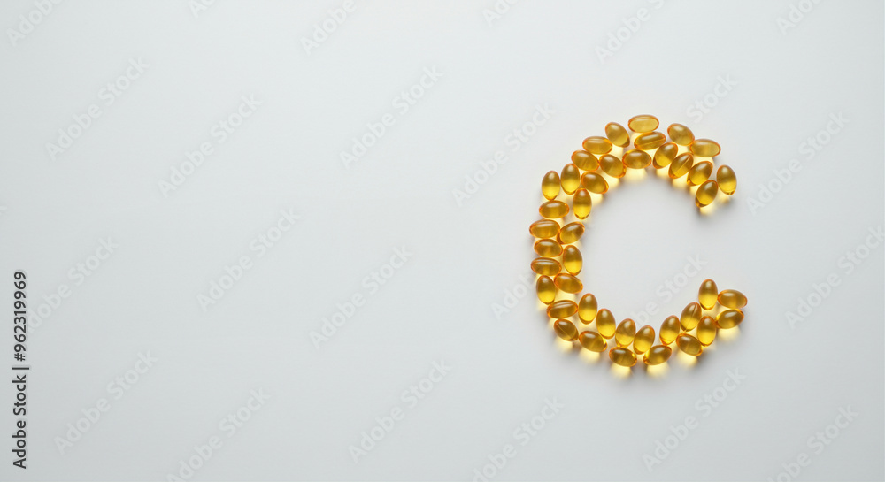 Gel capsules forming letter C with vitamins and supplements for health Gel capsules forming letter C with vitamins and supplements for health