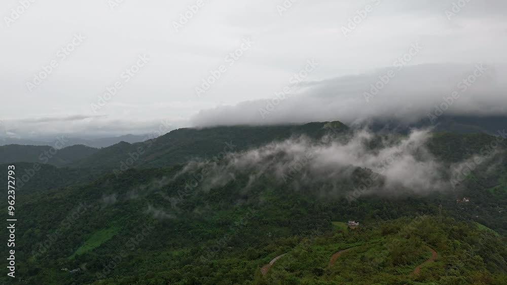 A hyper-lapse from the aerial view of mighty foggy hills in Kannur, Kerala in lush green monsoon evening shot captured during the rain A hyper-lapse from the aerial view of mighty foggy hills in Kannur, Kerala in lush green monsoon evening shot captured during the rain