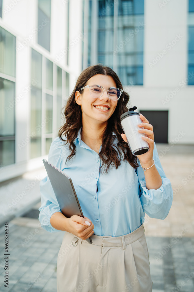 Fototapeta premium Young successful woman is going to work at modern business building 
