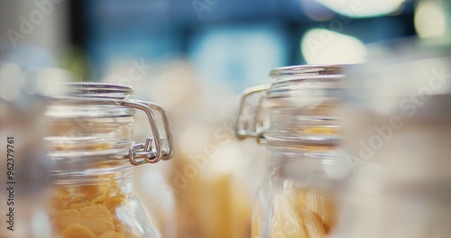 Fotografie Selective focus of reusable jars filled with cereals and pasta to help with low carbon footprint
