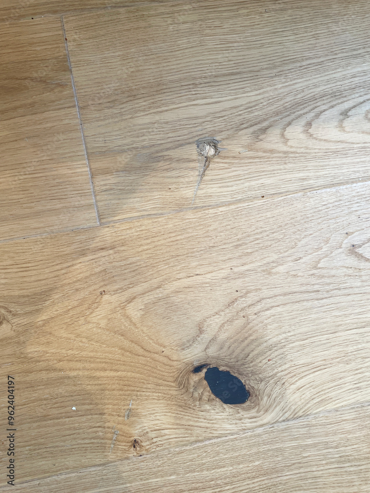 Close-up view of natural oak wood texture highlighting knots and grain patterns on a wooden floor surface, hole on floor Close-up view of natural oak wood texture highlighting knots and grain patterns on a wooden floor surface, hole on floor