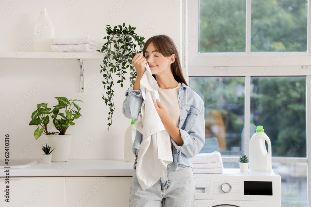 © Pixel-Shot - Young woman smelling clean towel in laundry room © Pixel-Shot - Young woman smelling clean towel in laundry room