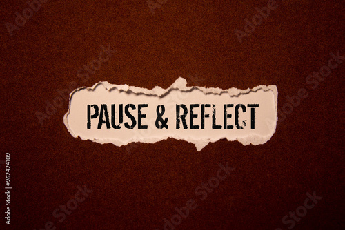 Pause and reflect word on a business card on a red notebook